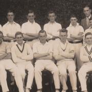 Ken, in his whites, 4th from left, back row.
