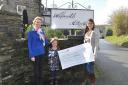 Mandy Stirling and her god-daughter Belle Curran present a cheque to Dr Theresia Mikolash for Breathing Matters.