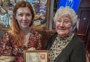 Pub manager Nicola Morris is presented with her award by CAMRA branch chair Alwen Thomas.