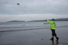 HM Coastguard Cardigan station commemorated 200 years of coastguard work by casting a throw line into the sea. Cardigan's newest recruit Paul Conway is pictured casting throw line into the sea at Poppit Sands.