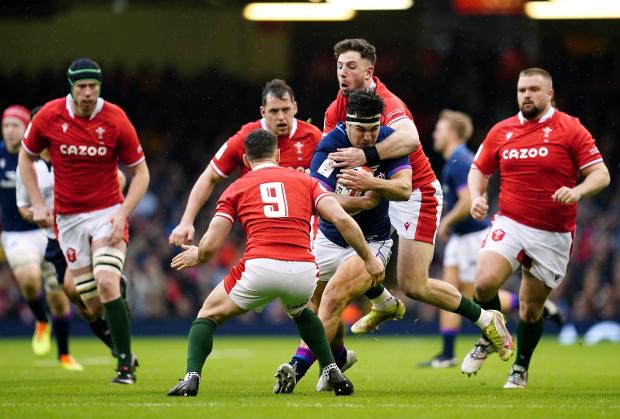 Milford Mercury: Wales' Alex Cuthbert tackles Scotland's Stuart McInally during the Guinness Six Nations match at the Principality Stadium, Cardiff. Picture: PA
