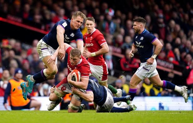 Milford Mercury: Wales' Jac Morgan is tackled by Scotland's Hamish Watson and Duhan van der Merwe (left) during the Guinness Six Nations match at the Principality Stadium, Cardiff. Picture: PA
