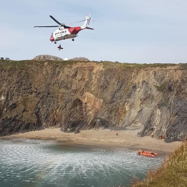 Milford Mercury: The minister was winched onto a rescue helicopter which took him to hospital in Cardiff. Picture: St Davids RNLI